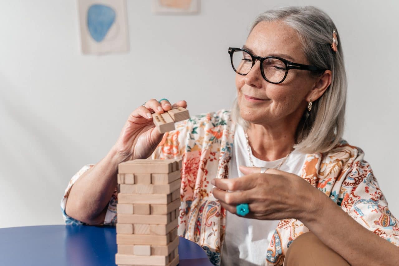 Older woman working on a puzzle.