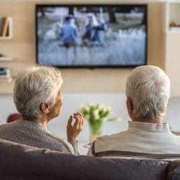 Older couple watching TV together.