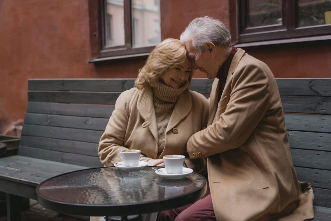 Older couple enjoying a date at an outdoor cafe.